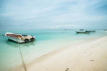 Boats anchored in turquoise waters at Tortuga Island, Venezuela