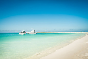 Yachts anchored near de beach in a beautiful place: Los Roques National Park, during a sunny day