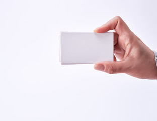 Obraz premium empty white paper business cards in a female hand