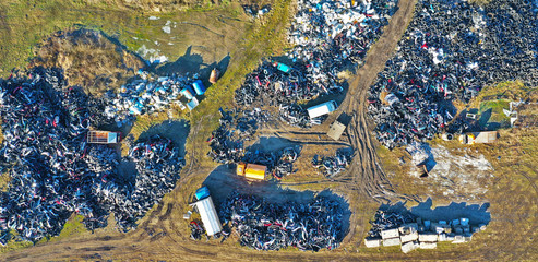 Aerial view on junkyard with rubbish, plastic and old rubber tires.