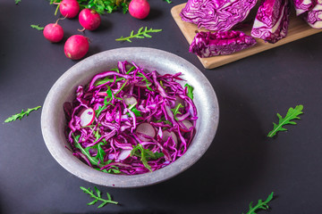 Obraz na płótnie Canvas Healthy salad with red cabbage, radish and arugula . Vegetarian concept