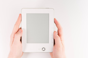 Holding E-book reader in hands. Book with hands isolated on white background