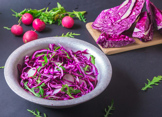 Healthy salad with red cabbage, radish and arugula . Vegetarian concept