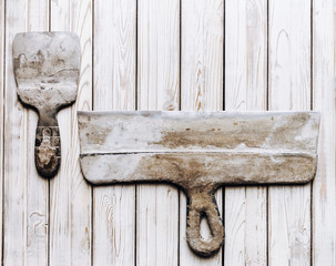 Spatulas with the remaining mortar. Gastarbeiter or guest worker concept. Handyman. Tools for...