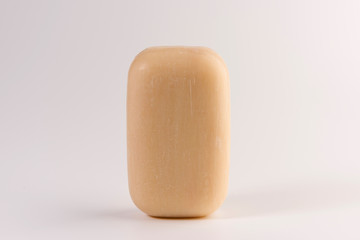 piece of beige soap isolated on a white background