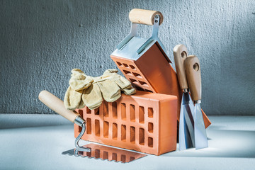 bricks gloves and plastering tools on concrette