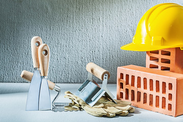 plastering composition bricks helmet gloves trowels on concrette