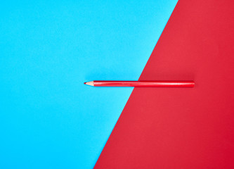 red wooden pencil on color abstract background