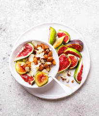 Yogurt Greek with figs Almond and Mead. Healthy Food Concept. Useful breakfast on the stone background.Diet Nutrition.Top View.Copy space for Text.