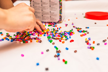 Obraz na płótnie Canvas plenty of toy beads in child hands