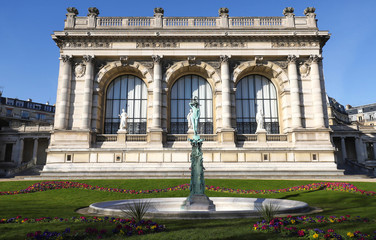 Blue sky and green grass the perfect backdrop for beautiful old architecture and fountain statue at...
