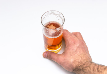 glass of beer in hand isolated on white background.