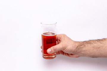 glass of beer in hand isolated on white background.