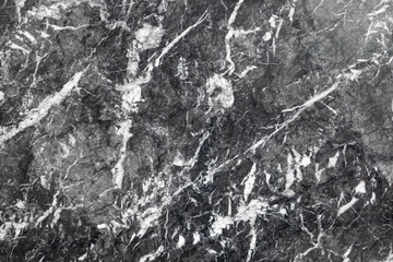 Black marble texture. Closeup photo of patterned granite wall