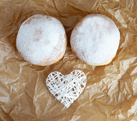 Sugared doughnuts decorated with a white heart top view, funny food concept