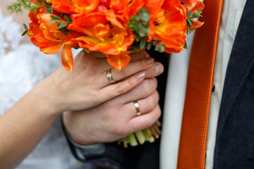 Wedding photo. Hands of the newlyweds with wedding rings