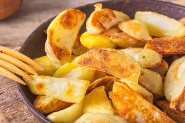 Crisp golden deep fried, french fries hot potatoes, frying and ready to be eaten, really yummy. Fried potatoes in the old cast-iron pan