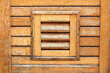 Decorative wooden boards texture made to look like window blinds on new wooden house wall on warm...
