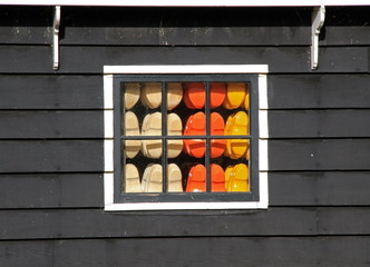 colourful dutch wooden clocks in window
