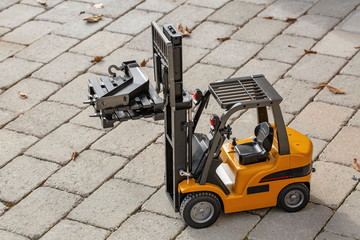 Fototapeta na wymiar View of radio controlled model forklift. Free time Children and adults concept. Hobby. Toys. 