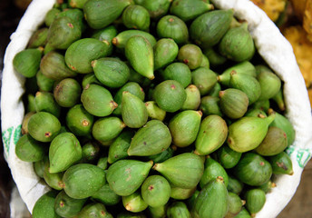 Basket of fresh harvested green Colombian Breva fruit or figs, in a farmers market in Colombia, South America