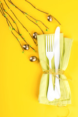 Easter table setting with  Kitchen cutlery on a bright yellow background. Holiday decoration.Happy Easter concept. Top View. Flat Lay.Copy space for Text.
