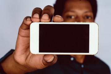 Afro American man holding smartphone.