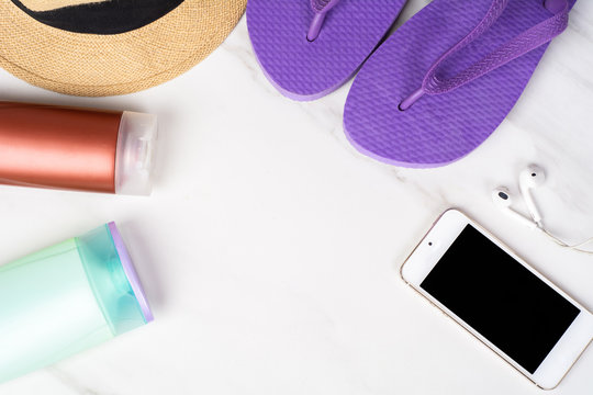 Smartphone, flip-flops, sunscreen and hat.