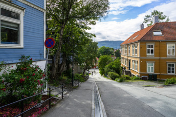 A picturesque street with colorful wooden houses in Bakklandet district, the old part of Trondheim, Norway