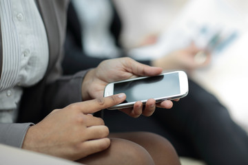 close up.business woman presses the screen of the smartphone