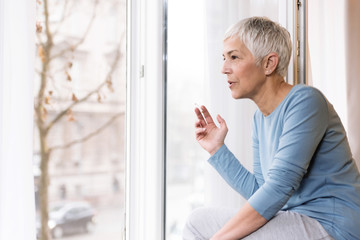 Mature woman smoking - Powered by Adobe