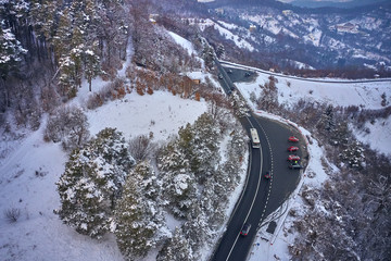 The road seen from the air with snow-covered trees