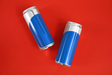 Blank metal cans on color background, flat lay. Mock up for design