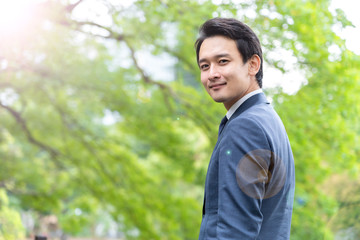 portrait of asian businessman in park