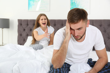Young couple arguing in bedroom. Relationship problems
