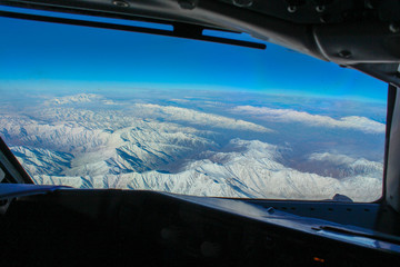 view of the mountains from the cockpit of an airplane