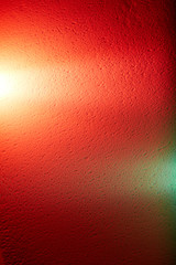 Red background with a spot of green and rays of light