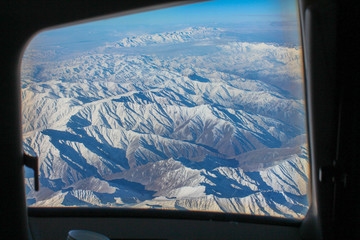 view of the mountains from the cockpit of an airplane