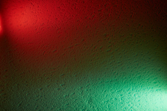 Red And Green Lanterns On A Textural Background Shine Meeting Each Other