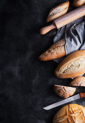 Fresh bread on a black chalkboard. Top view with copy space