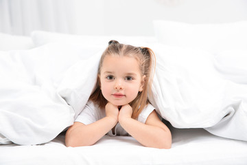 Beautiful little girl in bed at home. Bedtime schedule