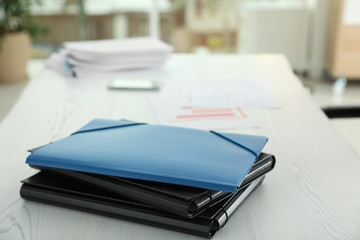 Stack of folders with documents on office table. Space for text