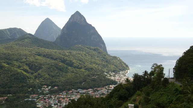 Steady shot of the Pitons, the most popular landmark in St. Lucia, with the town of Soufriere and the coastal view 