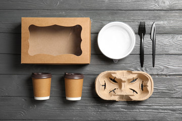 Fototapeta na wymiar Different containers for mock up design on wooden background, flat lay. Food delivery service