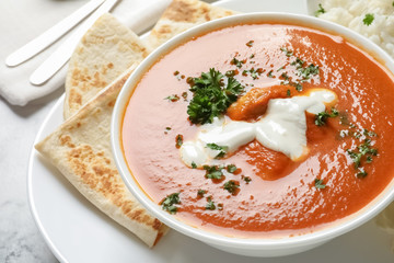 Delicious butter chicken in bowl served on table. Traditional Murgh Makhani dish