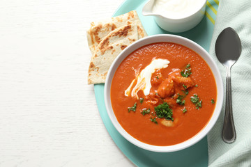 Delicious butter chicken served on table, top view with space for text. Traditional Murgh Makhani dish
