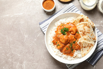 Delicious butter chicken with rice served on table, flat lay. Space for text