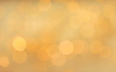 Gold glitter with bokeh effect on light background