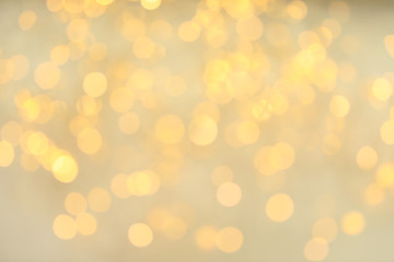 Gold glitter with bokeh effect on light background