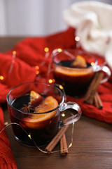 Beautiful composition with cup of mulled wine on table. Space for text